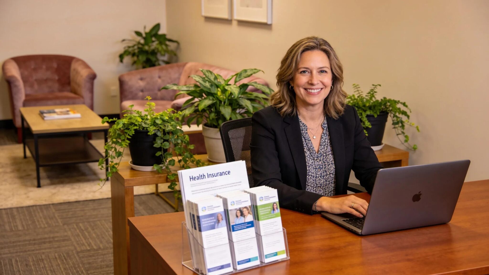 Office reception with health insurance consultant ready to assist small business owners